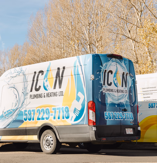 White Icon Plumbing & Heating Ltd. service van with blue water and yellow flame branding, displaying phone number 587-229-7718.